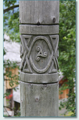 Carved triscele pole in the Celtic Village Hallein