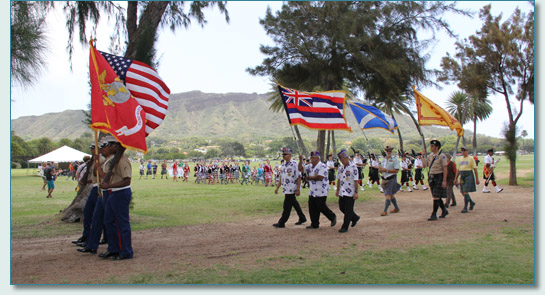 The Color Guard, Celtic Pipes & Drums of Hawaii and guests on Parade at the 32nd  Hawaiian Scottish Festival in Kapiolani Park, Waikiki, with Diamond Head beyond