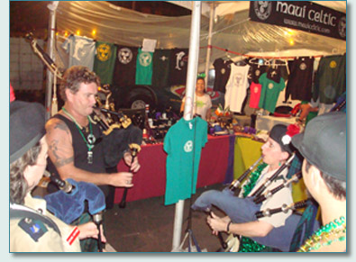 Hamish Burgess and Tina Yap piping at the Maui Celtic booth at he Honolulu S.Patrick's Day Block Party 2009